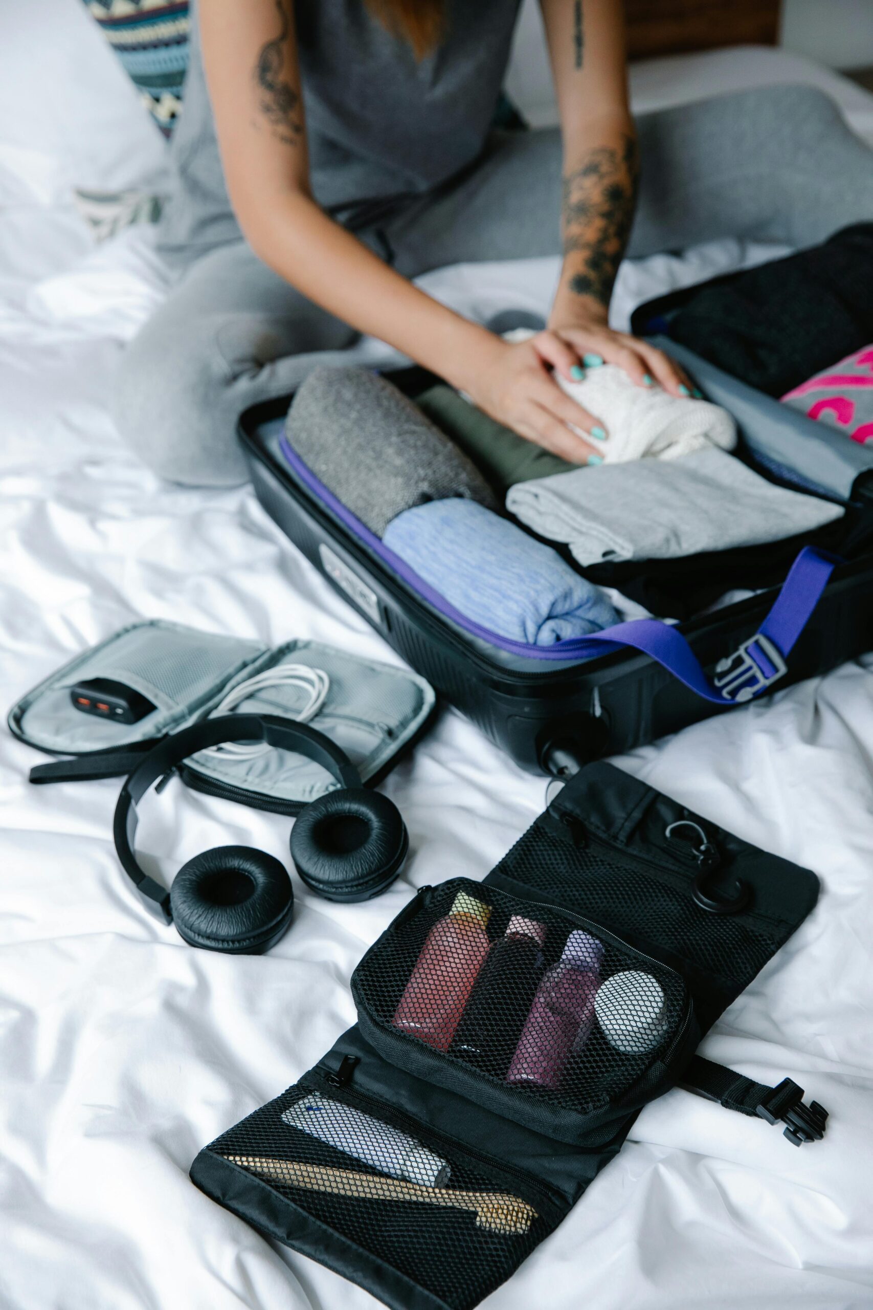 two-week vacation packing list flat lay with clothes shoes and toiletries