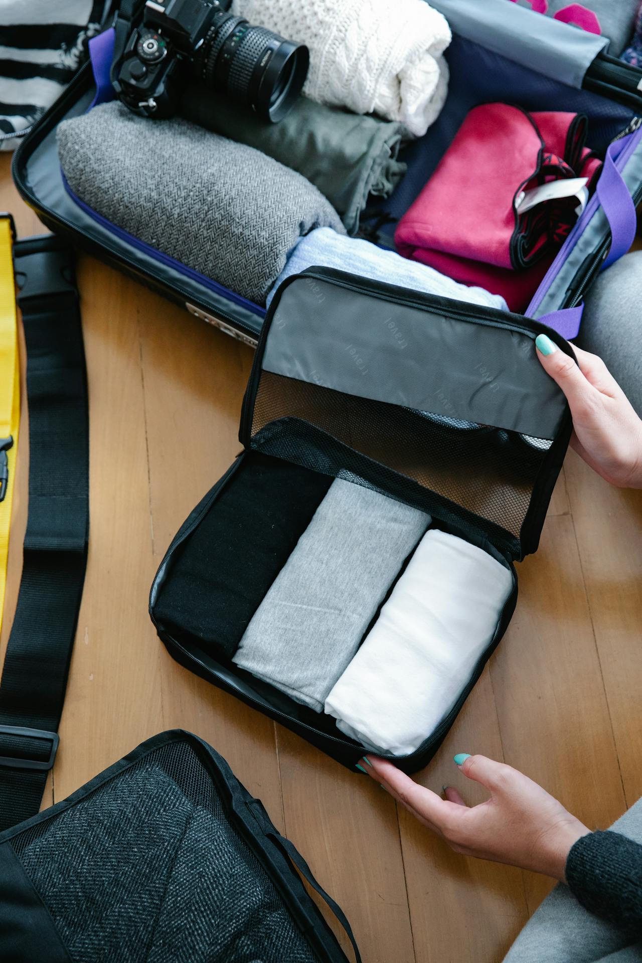 Packing cubes organizing clothes inside carry-on suitcase