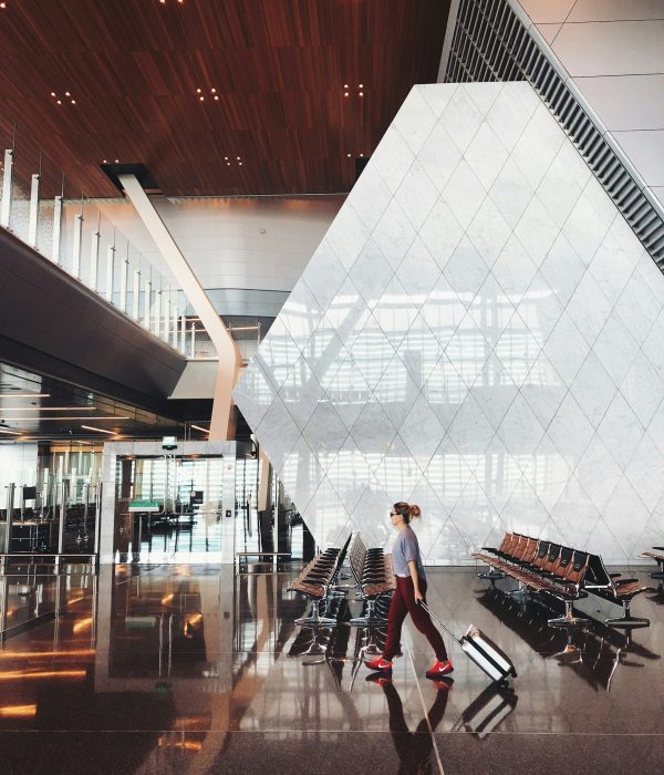 Smart carry-on packing guide traveler walking through airport with small luggage