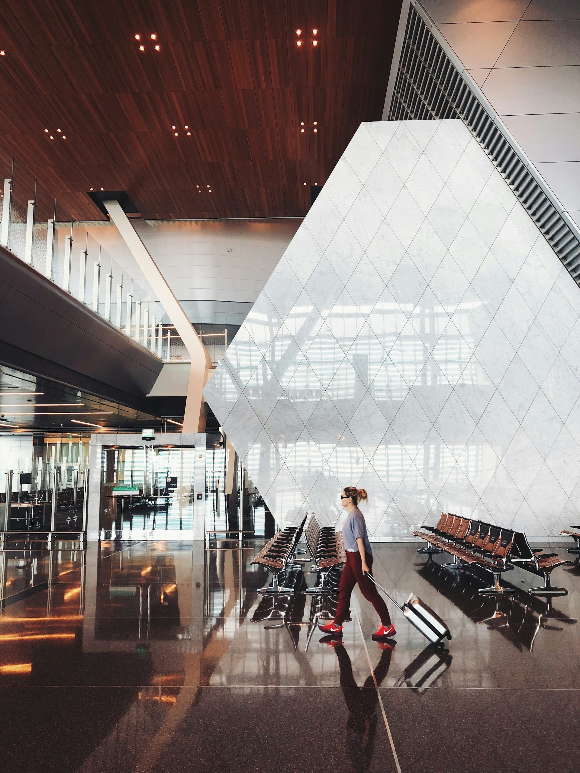 Smart carry-on packing guide traveler walking through airport with small luggage